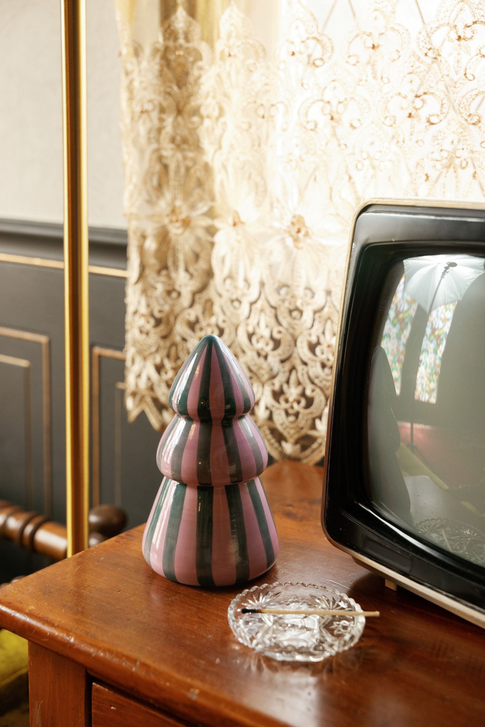 Cinnamon & Clove tree candle styled beside a vintage television