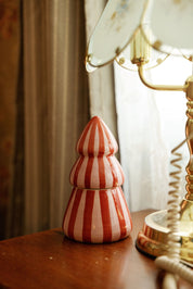 Pink Peppermint tree candle next to a vintage telephone